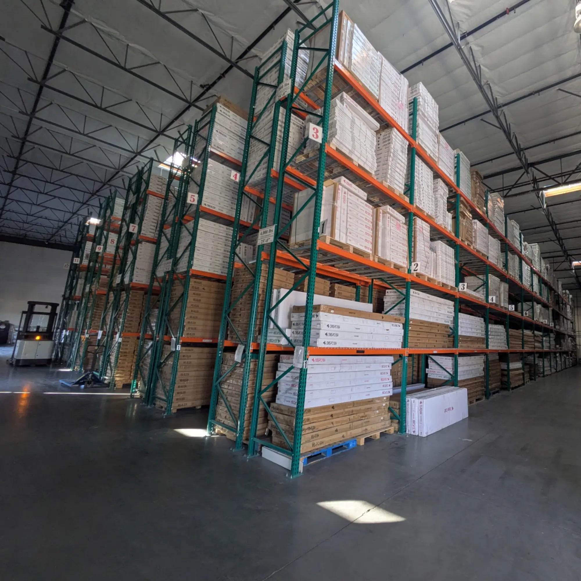 Large Las Vegas warehouse with tall storage racks filled with boxed kitchen cabinets and inventory ready for distribution and pickup.